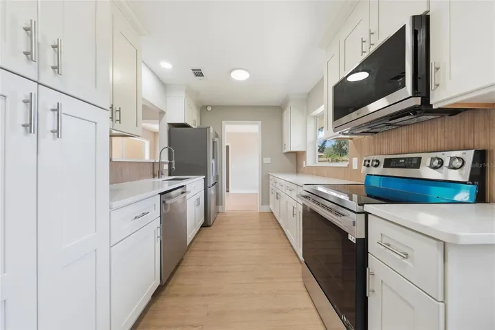 Kitchen with solid wood soft close cabinetry and stainless steel appliances