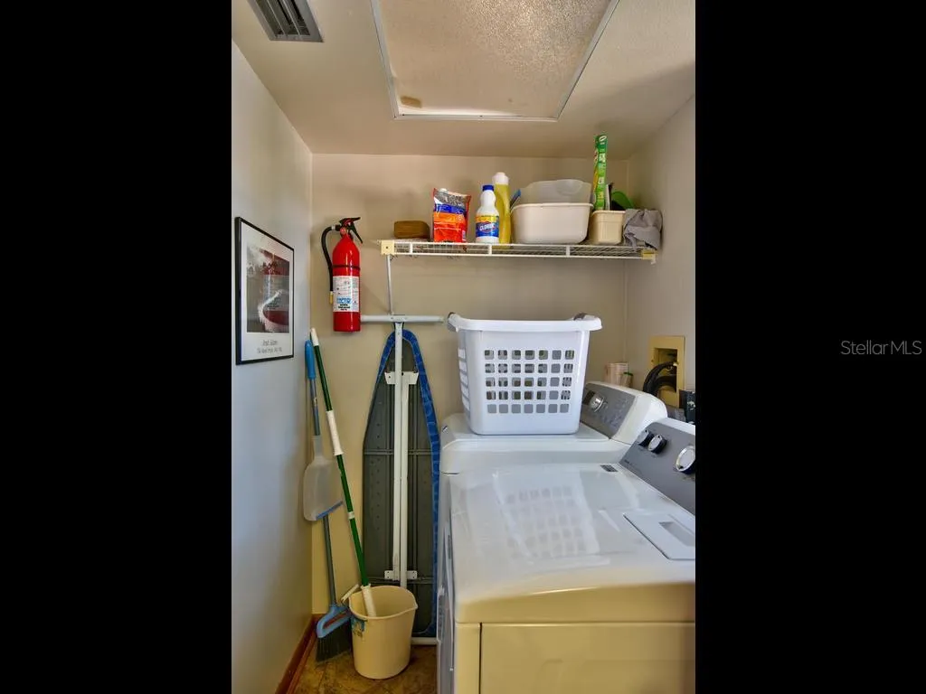 Laundry room has full size washer dryer off half bathroom