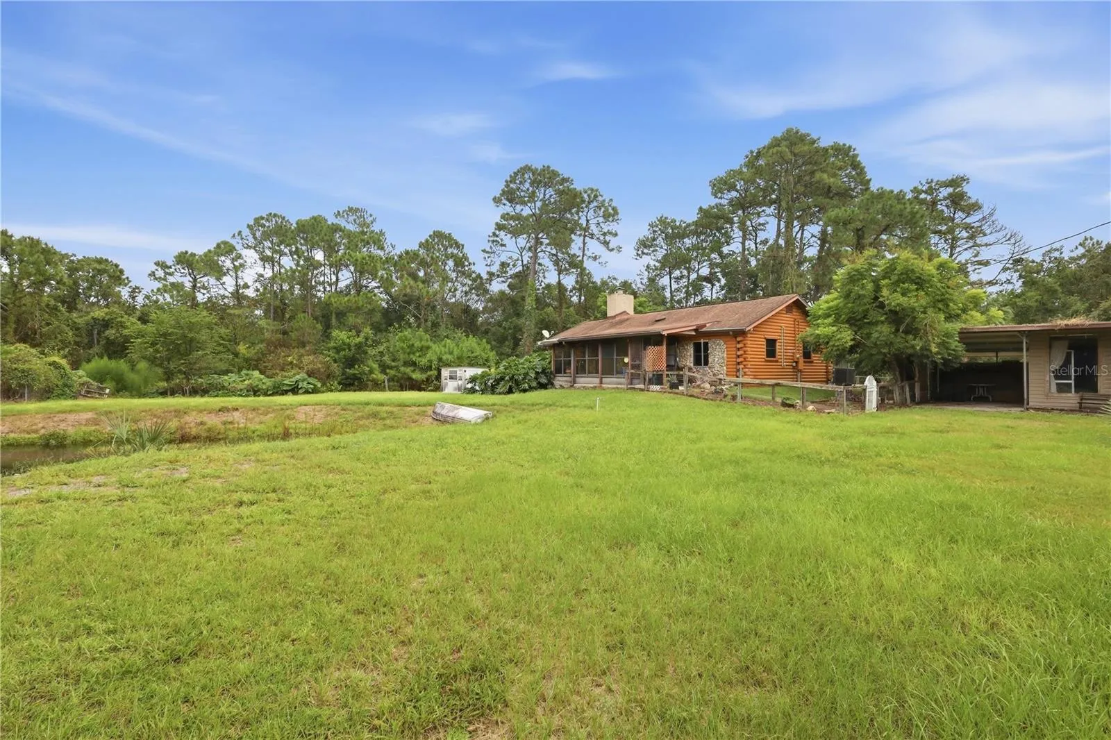 Front w/ Pond & Carport
