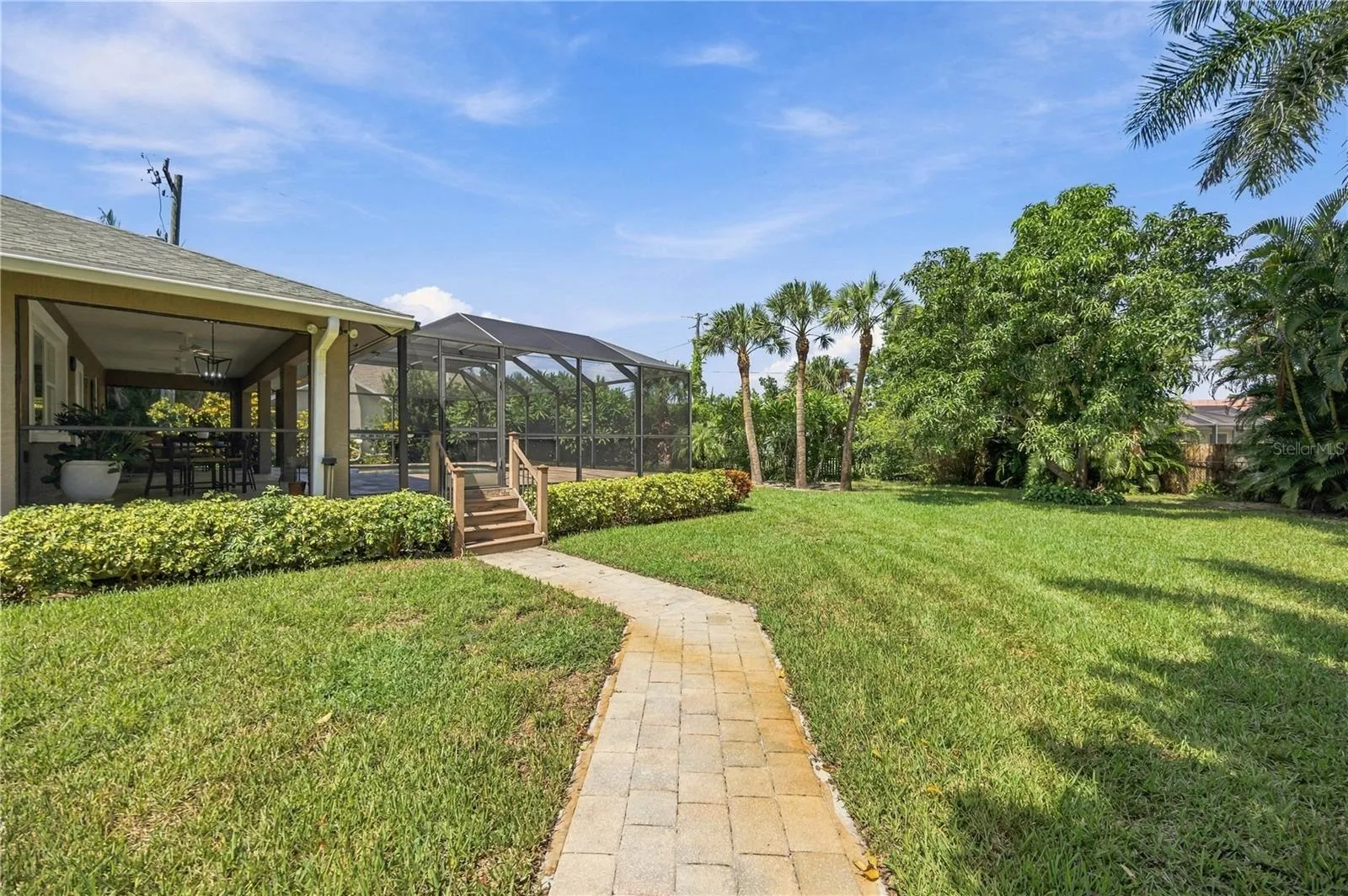 The backyard is large, manicured, and fenced, perfect for dog-lovers or privacy-maxxers