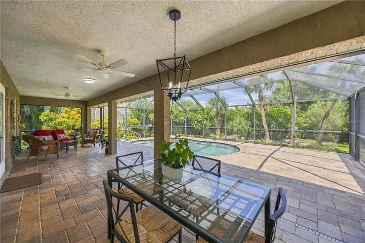 Covered patio area is large enough for both a large dining table and outdoor living room