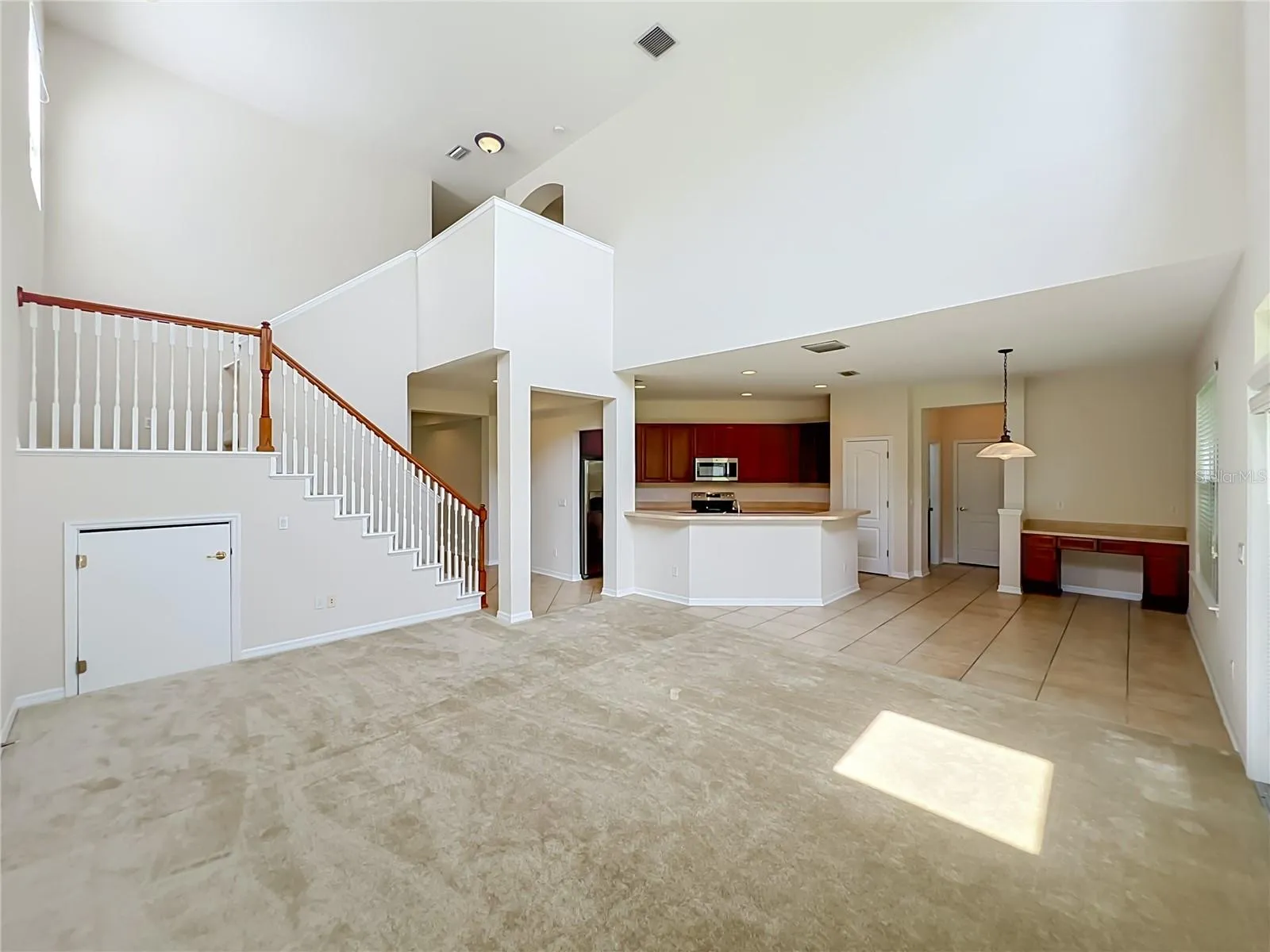 Family room/Kitchen/Dinette combination with 2-story ceiling