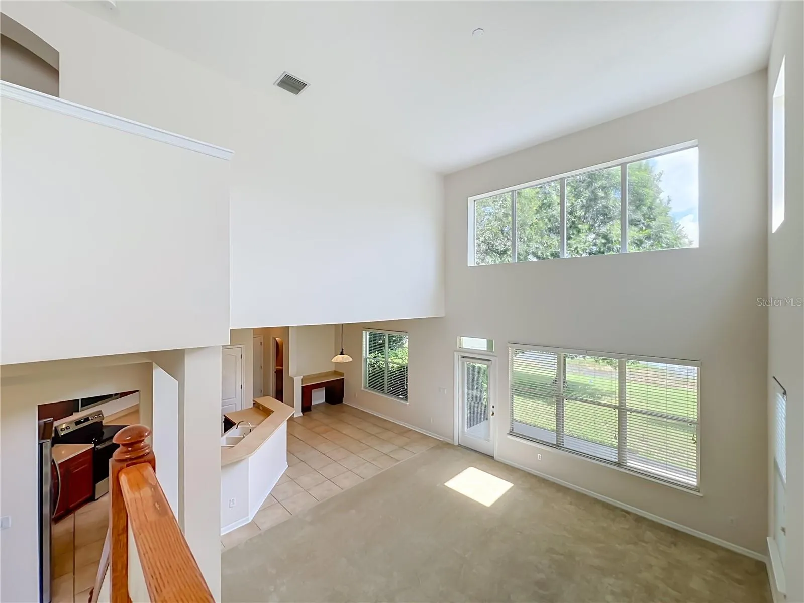 Family living area features lots of light from high ceilings and 2-story windows! Dinette area includes built-in desk, Kitchen features breakfast bar, New appliances, wood cabinets, and closet pantry