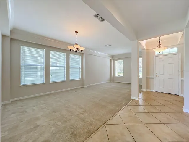 Living room/Dining room combination with high ceilings, crown moldings, Ceramic tile at the front door entryway