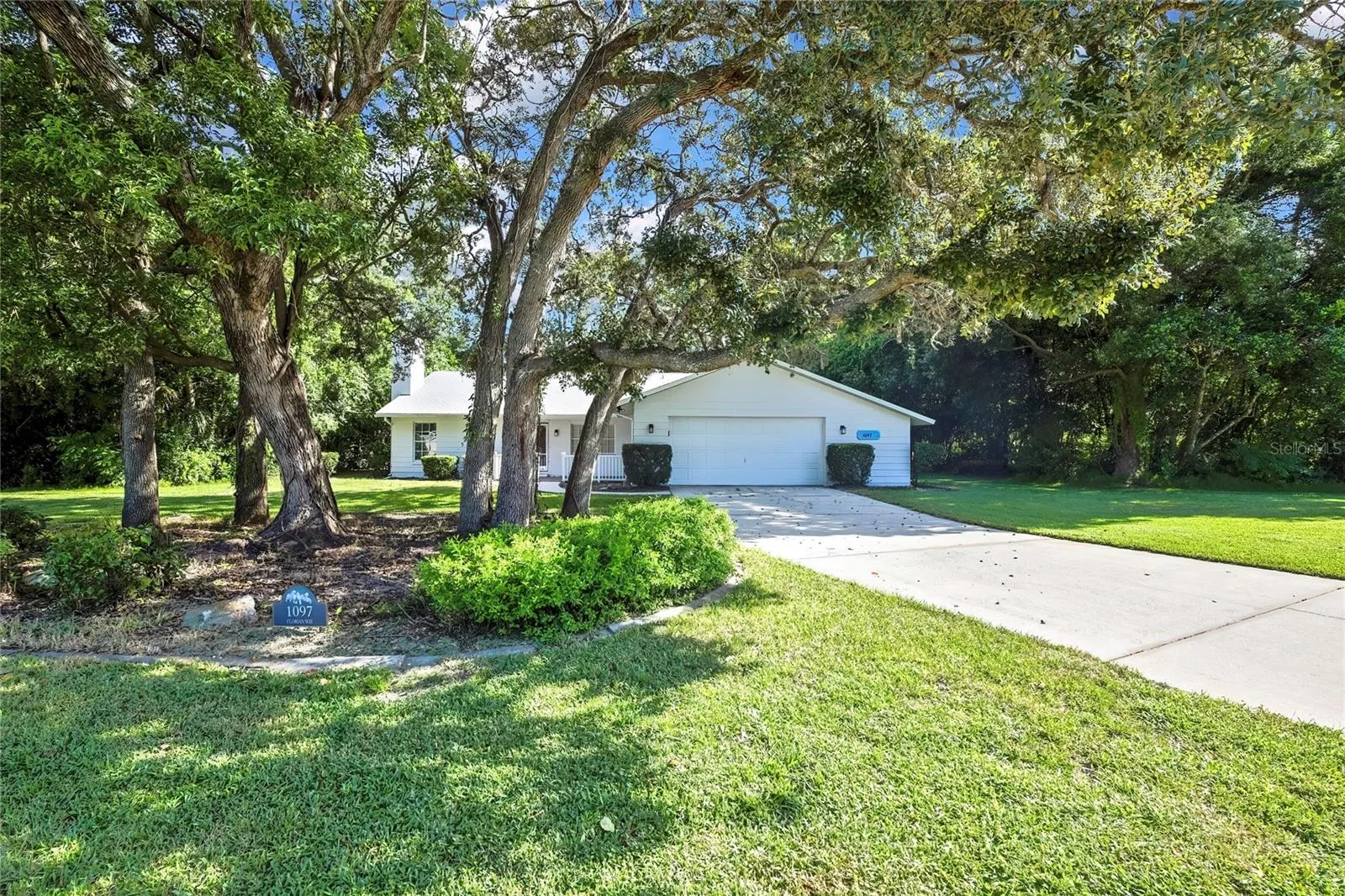 Inviting front approach with mature shade trees