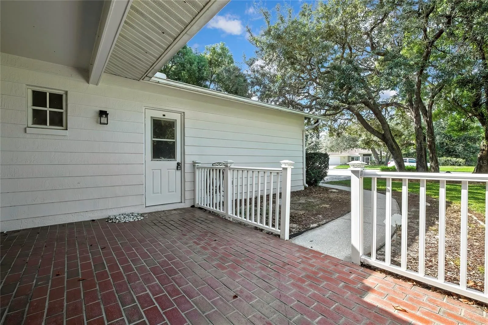 Shaded backyard bordered by mature vegetation