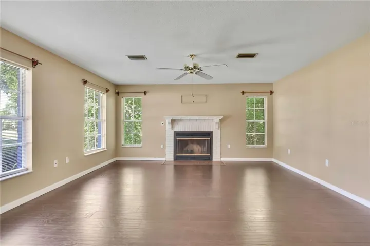 Living room with fireplace and abundant natural light