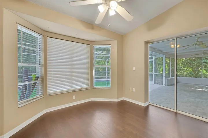 Bright breakfast nook with bay windows and lanai access