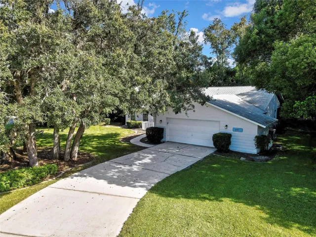 Aerial view of the home within its neighborhood setting