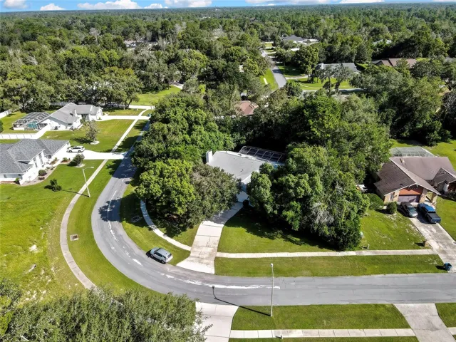 Aerial view showing the home's wooded surroundings