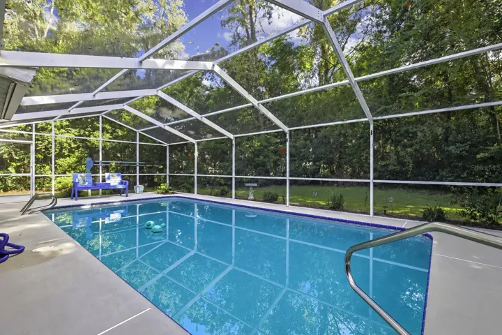 Swimming pool within a full screened enclosure
