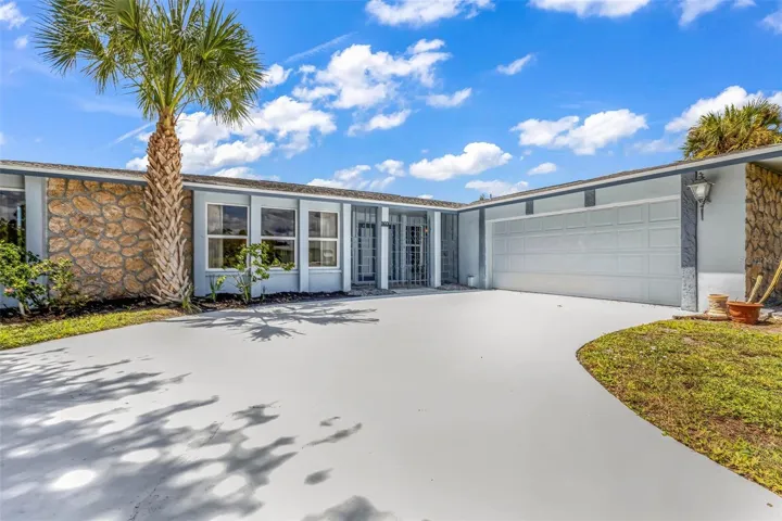 Expansive curved driveway.  Pull up, park, and enter through the unique gated entrance to your private courtyard and double door entry.