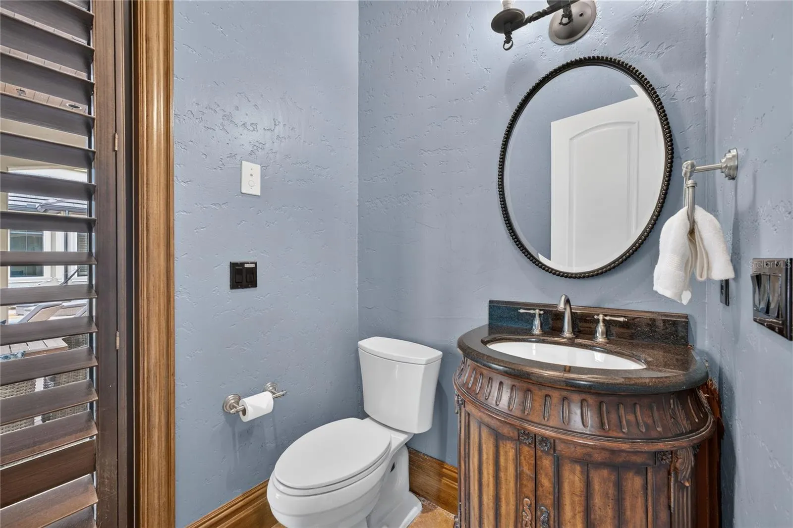 The Poolside Half Bath is accessible via the media/game room and outdoor dining area.