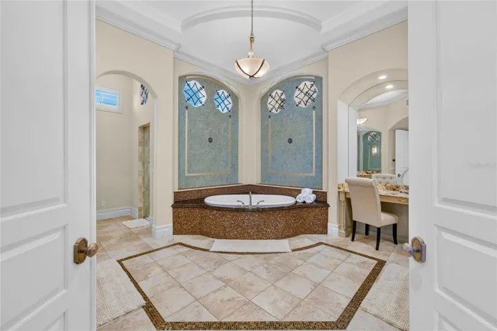 This primary bath was remodeled in 2020 and features soaking jetted spa tub, his &amp; her granite topped vanities, make-up area, STEAM multi-head shower , and toilet room with separate bidet.
