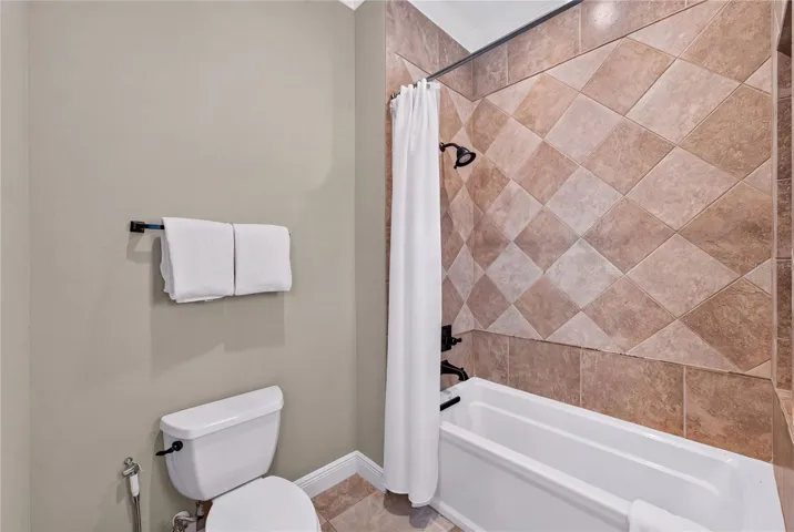 A separate room off the sink area in the Jack &amp; Jill bath houses toilet and tub/shower combo.