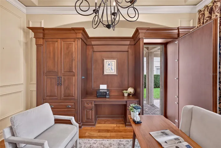 The last built-in cabinet door opens to reveal a "secret" private door to the exterior leading to right side garage from covered walkway.