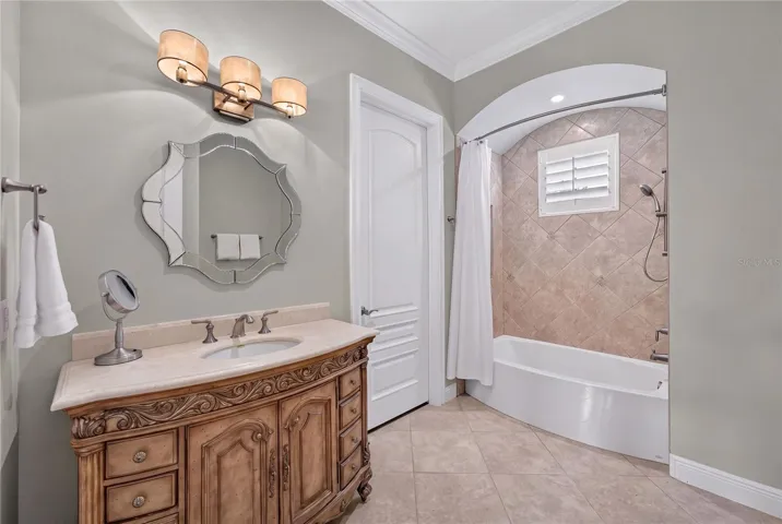 Ensuite Bath for Bedroom 7. The door shown leads to custom closet, SECONDARY UPSTAIRS LAUNDRY and another door to smaller mechanical area and attic access.