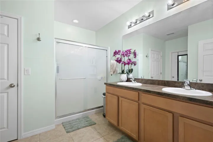 Primary bath with walk-in shower, dual sinks and large walk-in closet.