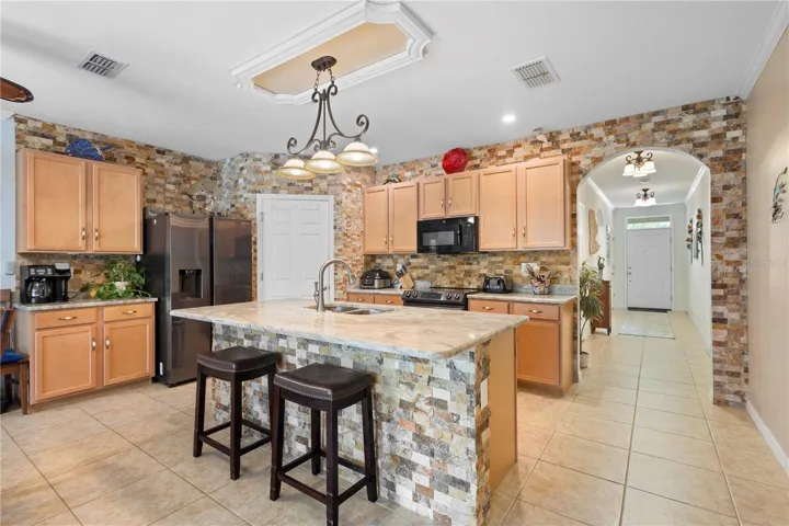 Beautiful brick accents adorn kitchen, bricks attached one by one.