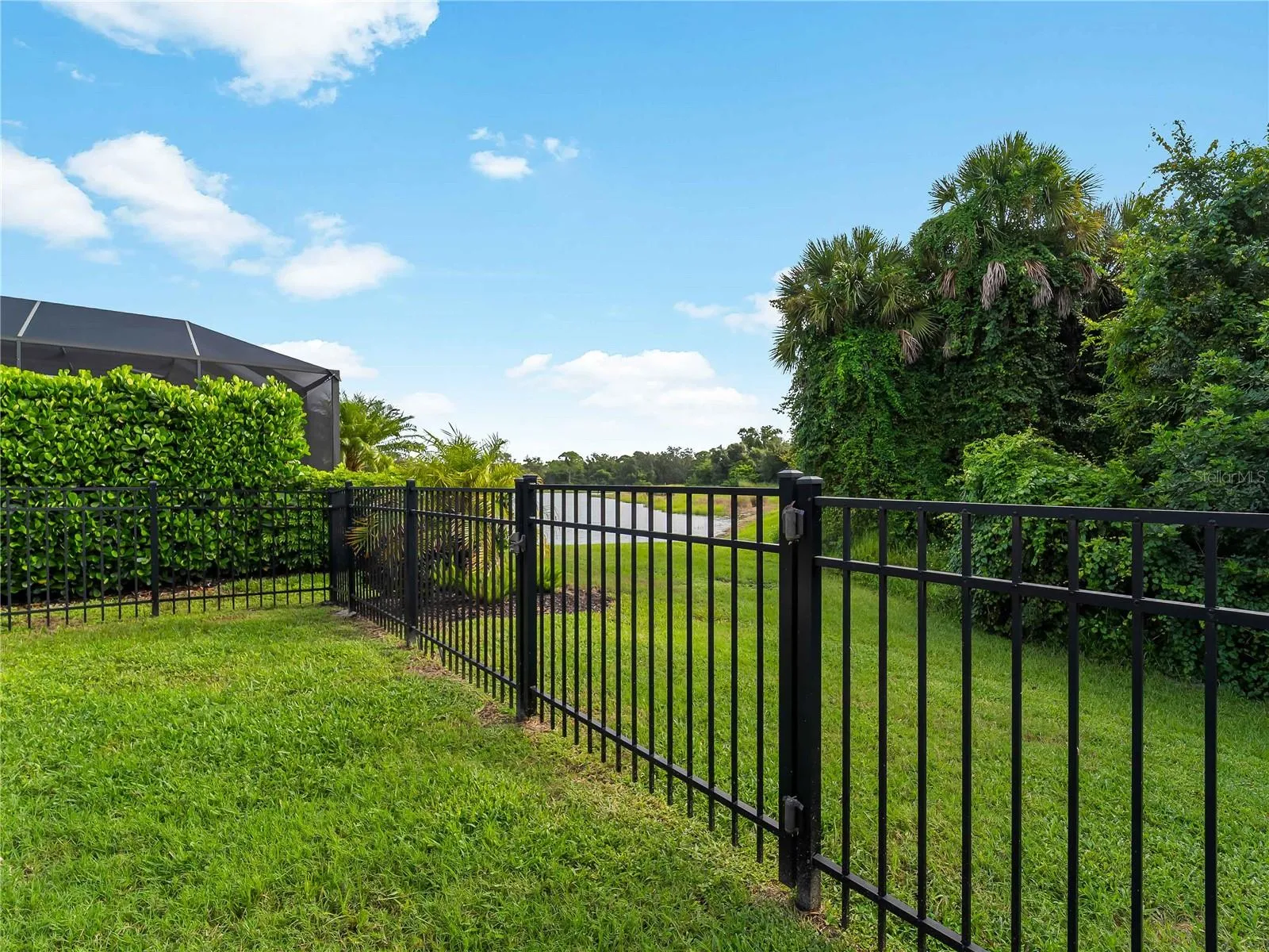 Fenced Back Yard with Water View