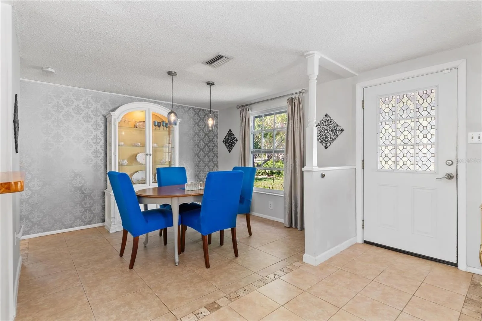 The dining area easily accommodates a full size table while remaining open to the main living spaces. Photo taken during prior occupancy.
