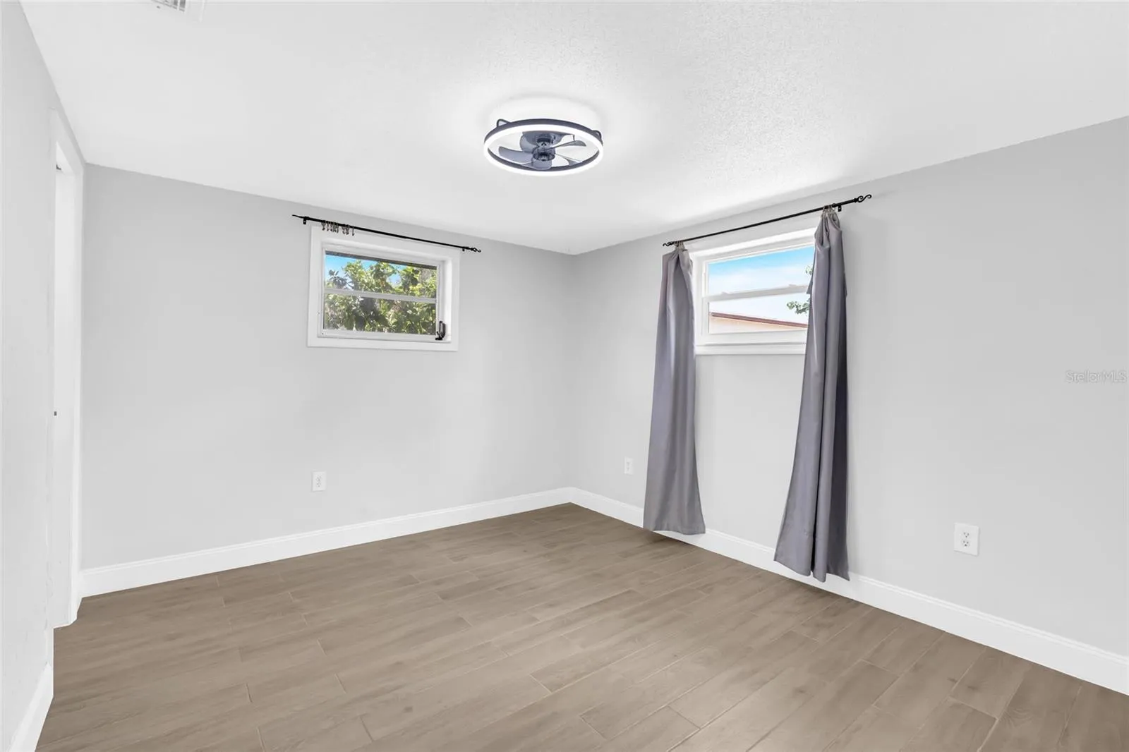 The primary bedroom offers generous proportions, updated flooring and the privacy of its own ensuite bath and walk in closet.