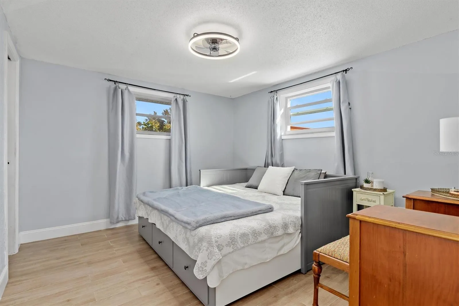 Spacious primary suite with room for a king size bed and additional furnishings, plus a walk in closet and private ensuite bath. Photo taken during prior occupancy.
