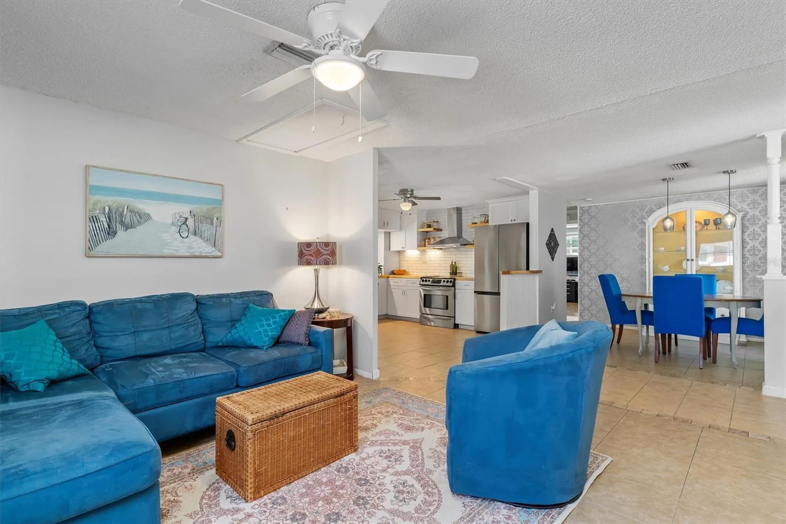 The open main living area provides generous space for gathering while connecting naturally with the dining area and kitchen. Photo taken during prior occupancy.