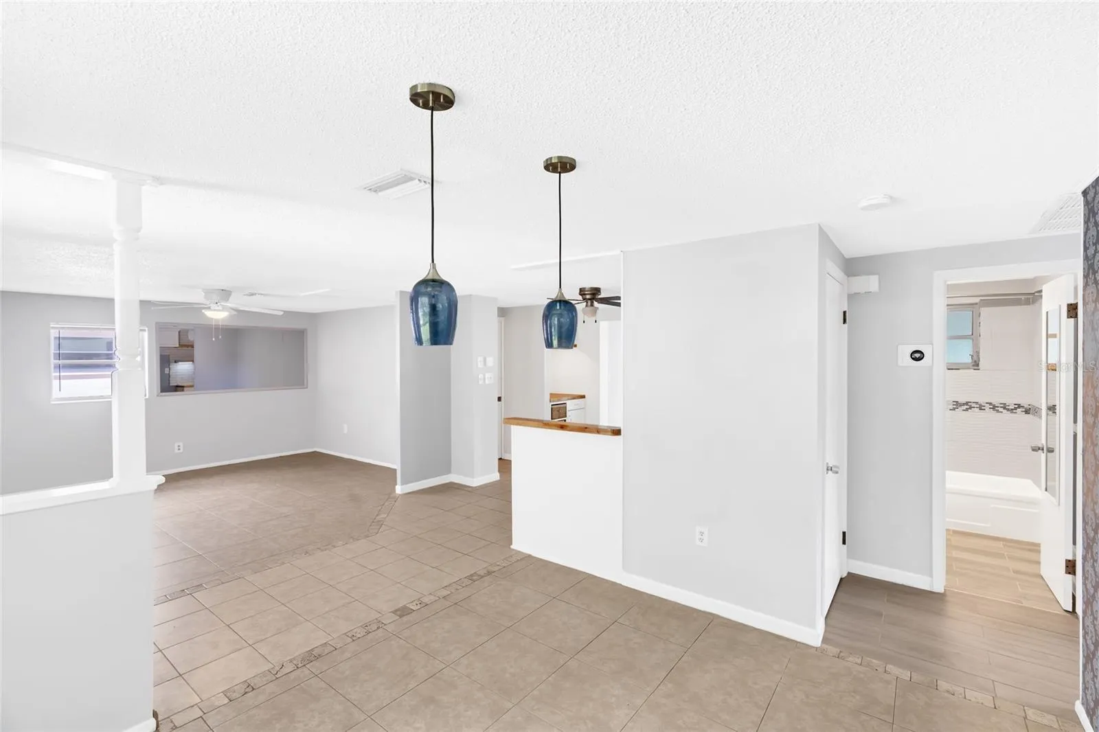 Natural light fills the dining area, with the front entry and main living room just steps away.
