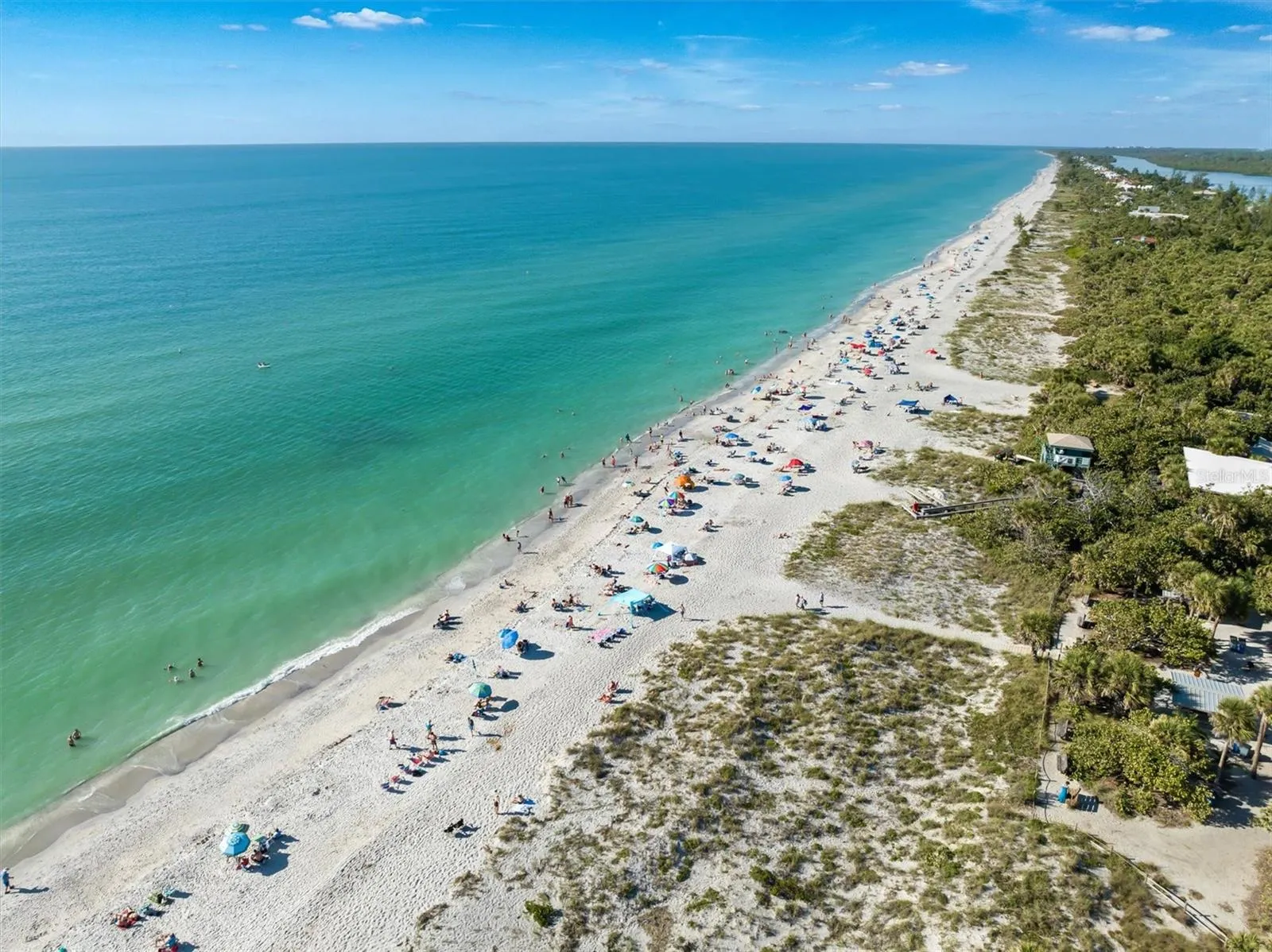 Aerial view highlights the home’s coastal Nokomis location, with the beach and Legacy Trail about 3 miles away, six Gulf beaches within approximately 8 miles, and easy access to Venice and Sarasota.