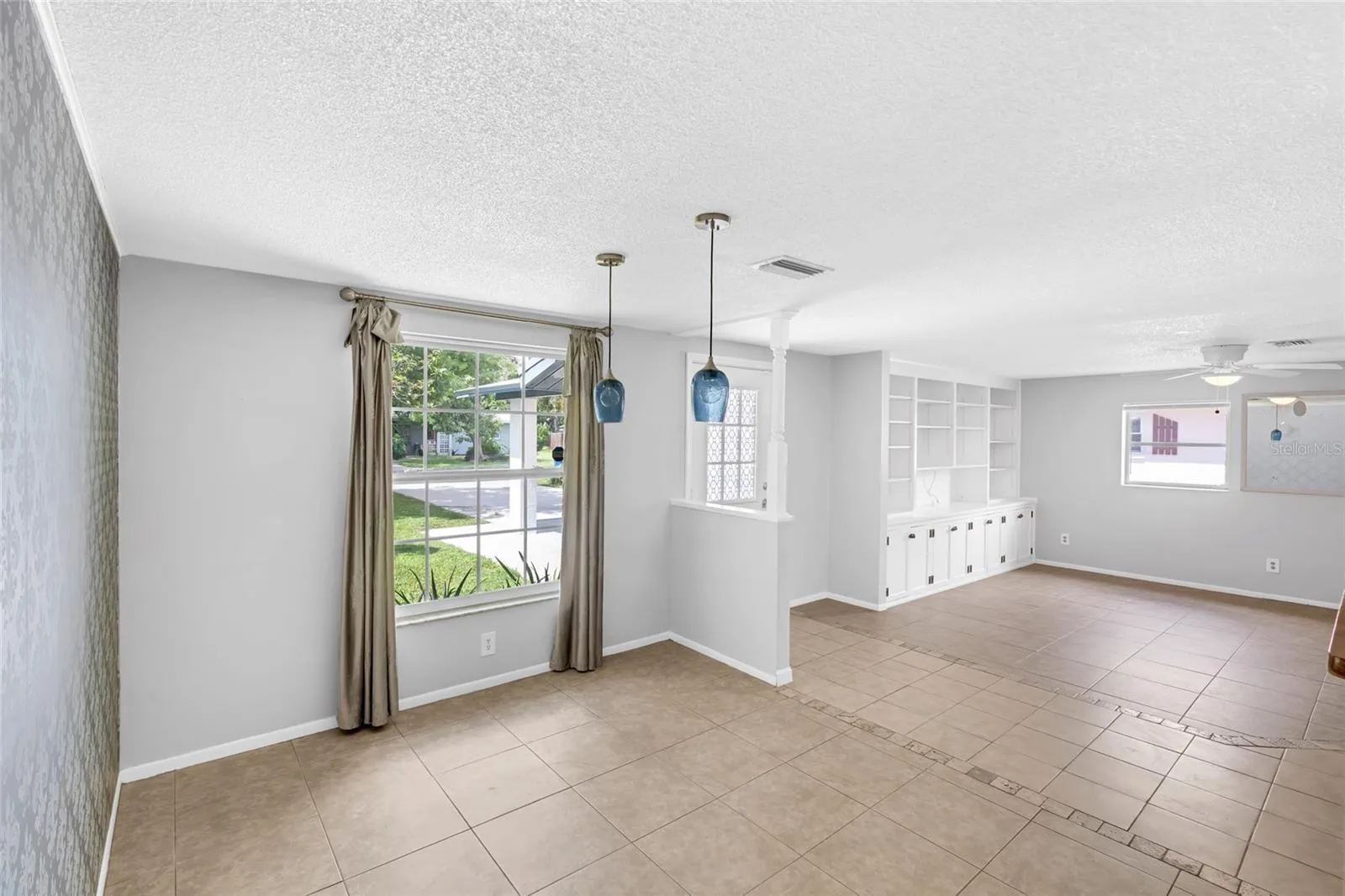 Natural light fills the dining area, with the front entry and main living room just steps away.