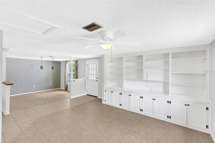 Built in shelving adds character and useful storage to the spacious front living area.