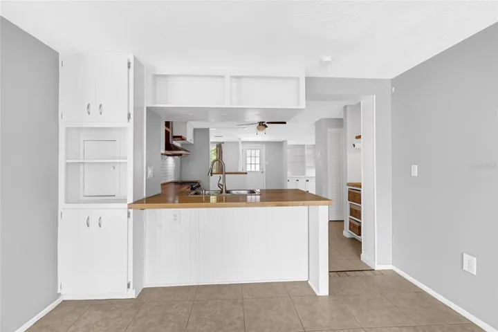 Breakfast bar adds casual seating and extra prep space while keeping the kitchen connected to the adjoining family room