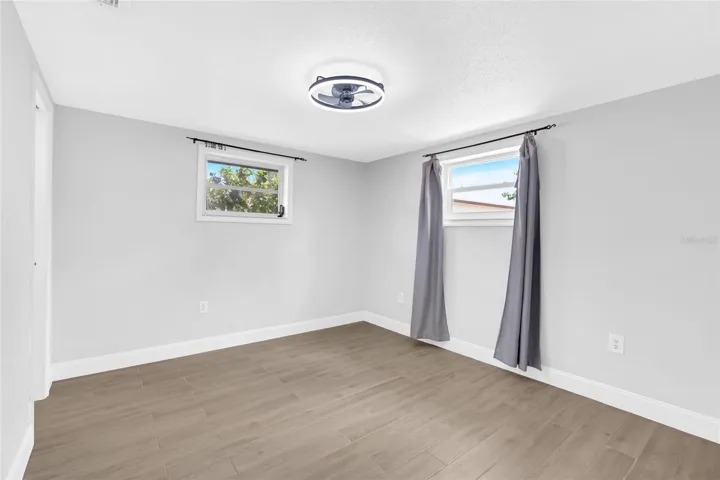 The primary bedroom offers generous proportions, updated flooring and the privacy of its own ensuite bath and walk in closet.