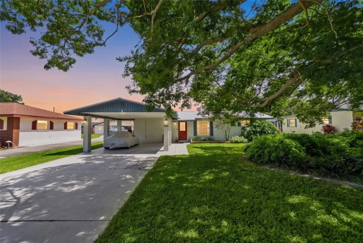 Welcome to 142 2nd Ave, a Nokomis pool home near Gulf beaches with a metal roof, covered carport and mature tropical landscaping.
