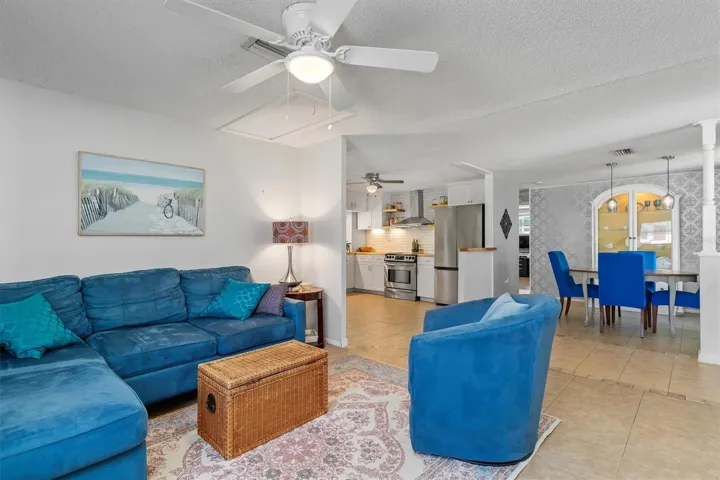 The open main living area provides generous space for gathering while connecting naturally with the dining area and kitchen. Photo taken during prior occupancy.