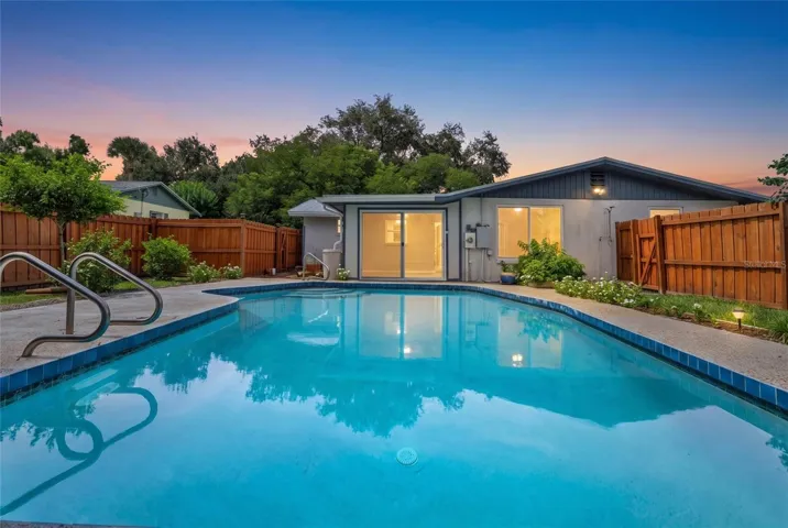 Private backyard pool surrounded by tropical landscaping, creating a peaceful Florida retreat just minutes from Gulf beaches.