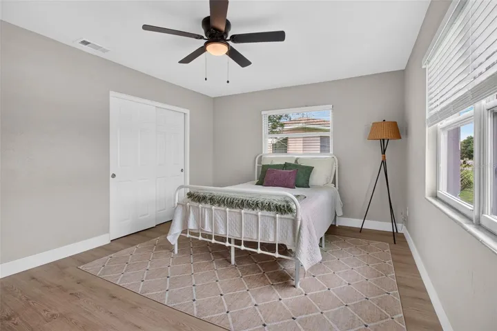 GOOD SIZED PRIMARY BEDROOM WITH BUILT IN CLOSET AND NEW CEILING FAN