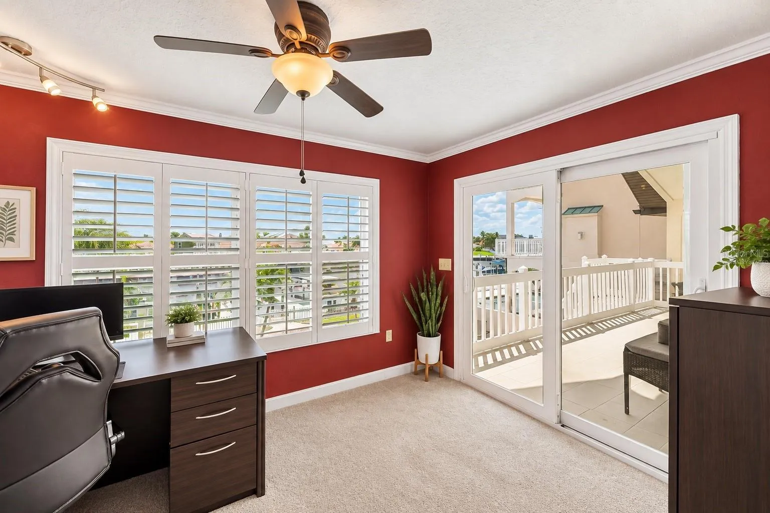 Primary suite office/den with slider to the rear balcony. Virtually staged – furniture and decor digitally changed.
