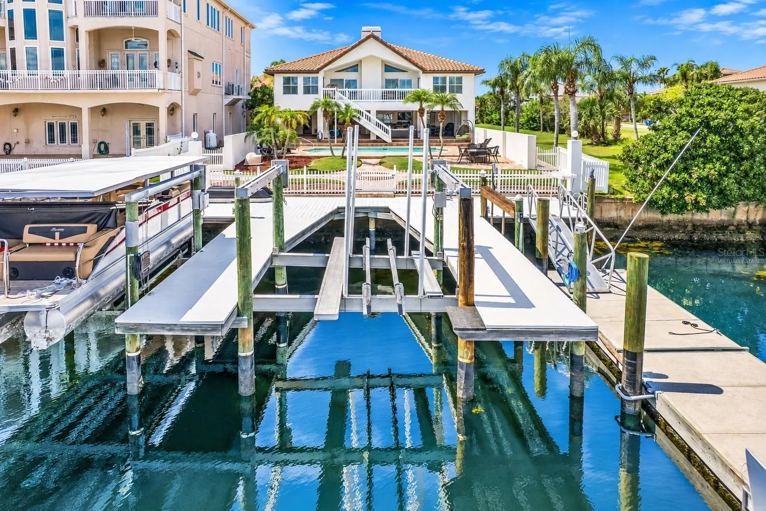 Private dock with boat lifts on the saltwater canal.