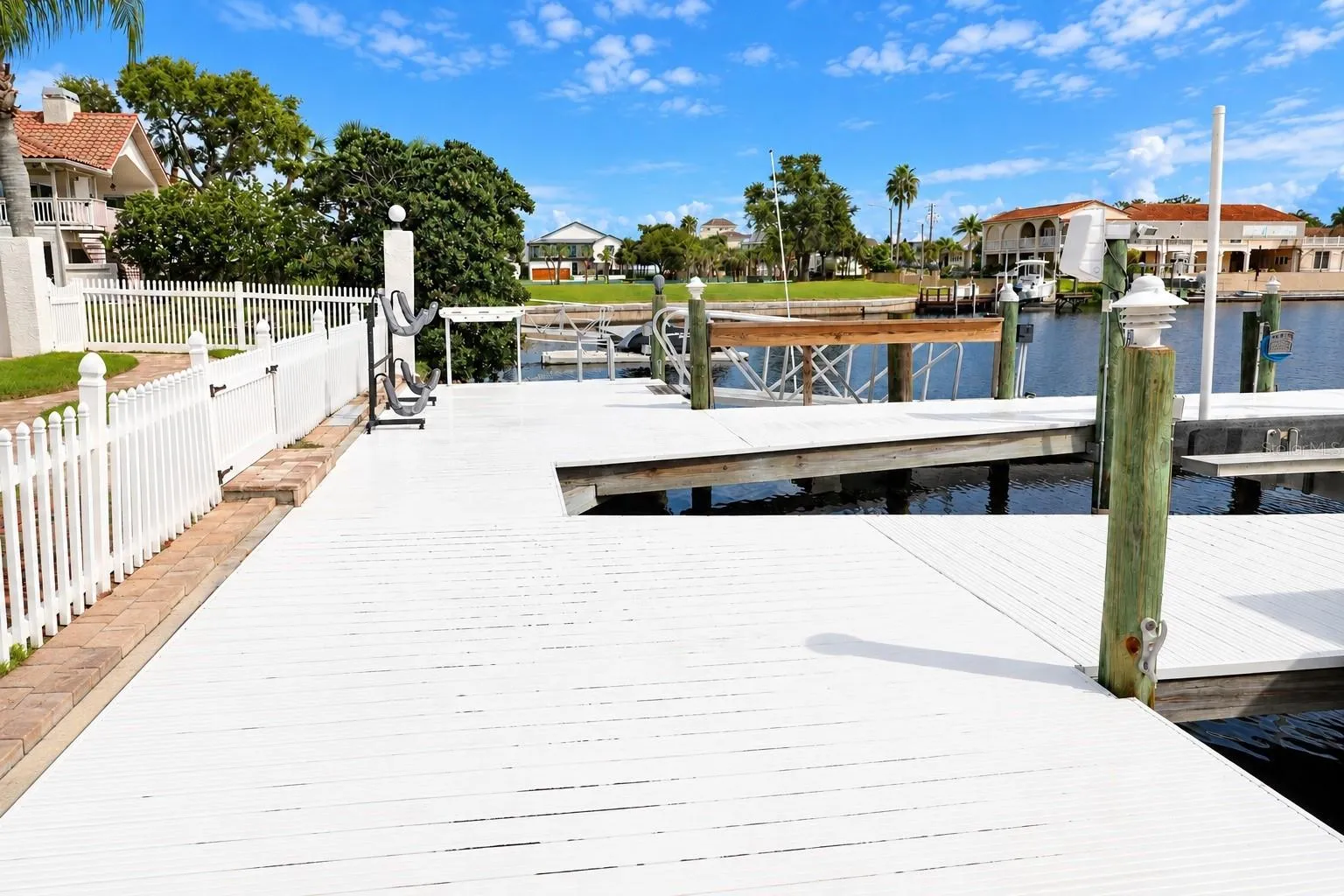 Private dock with boat lift and pilings on the saltwater canal.