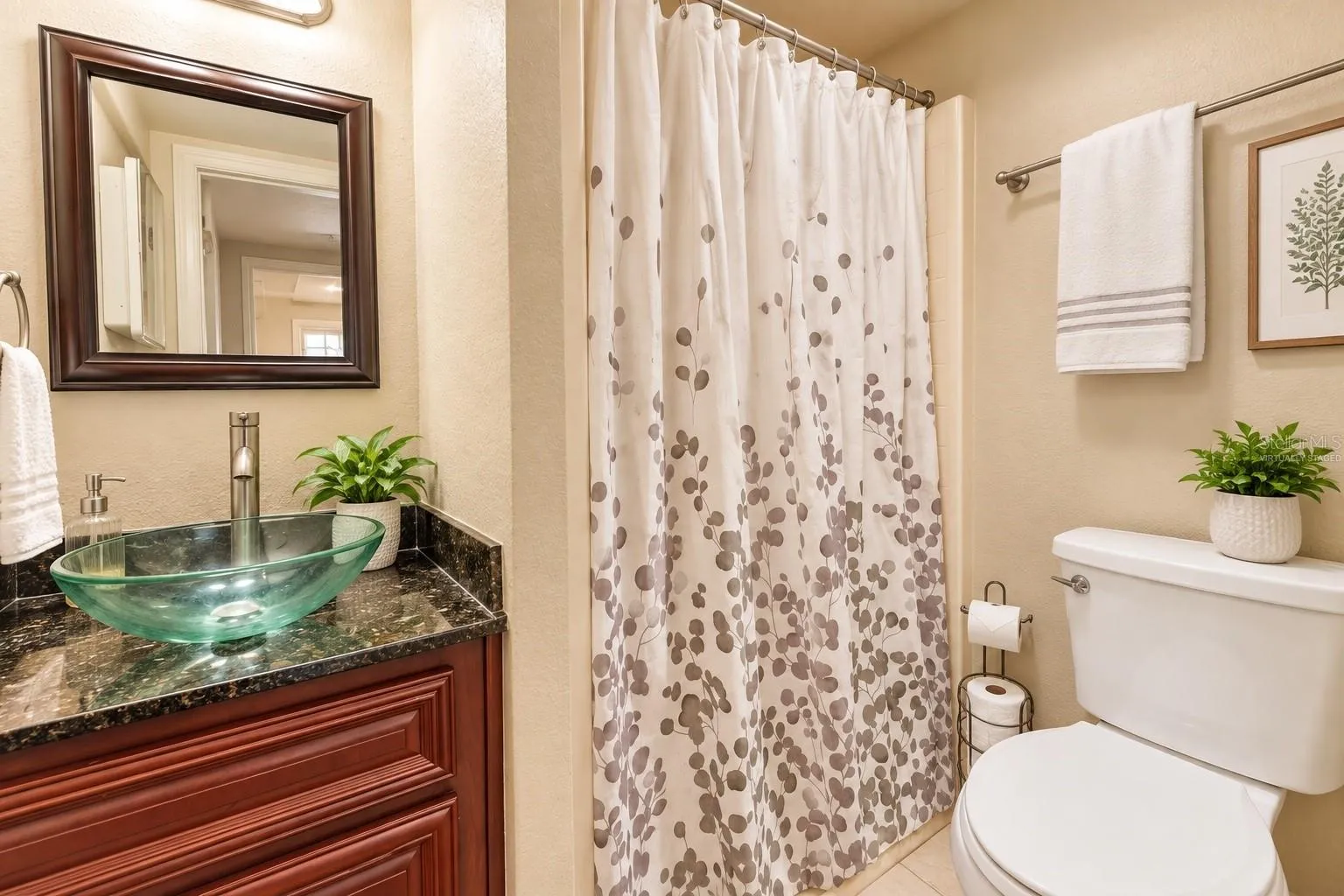 Ground-level pool bath with vessel sink. Virtually staged – decor digitally added.