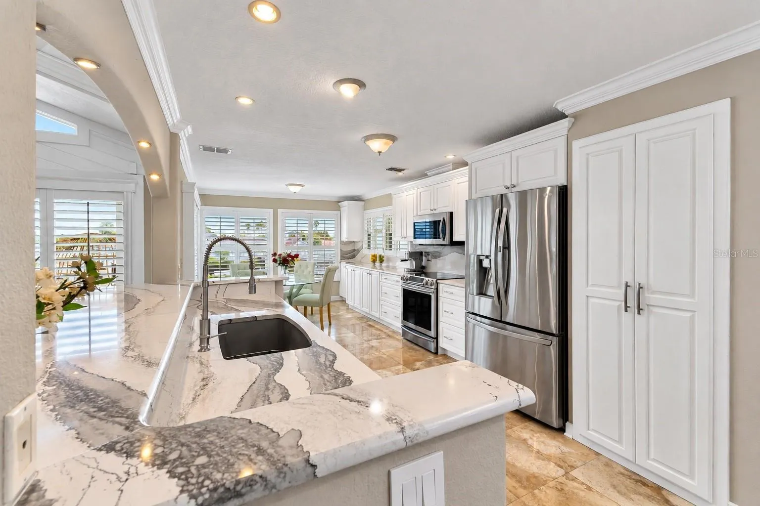 Kitchen with stone counters and stainless steel appliances.