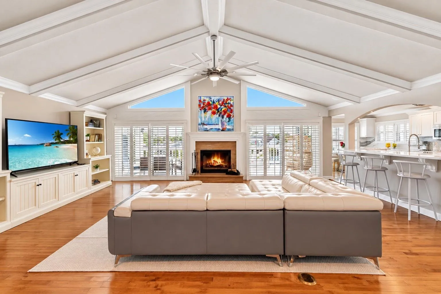 Great room with vaulted ceiling, wood-burning fireplace and built-ins.