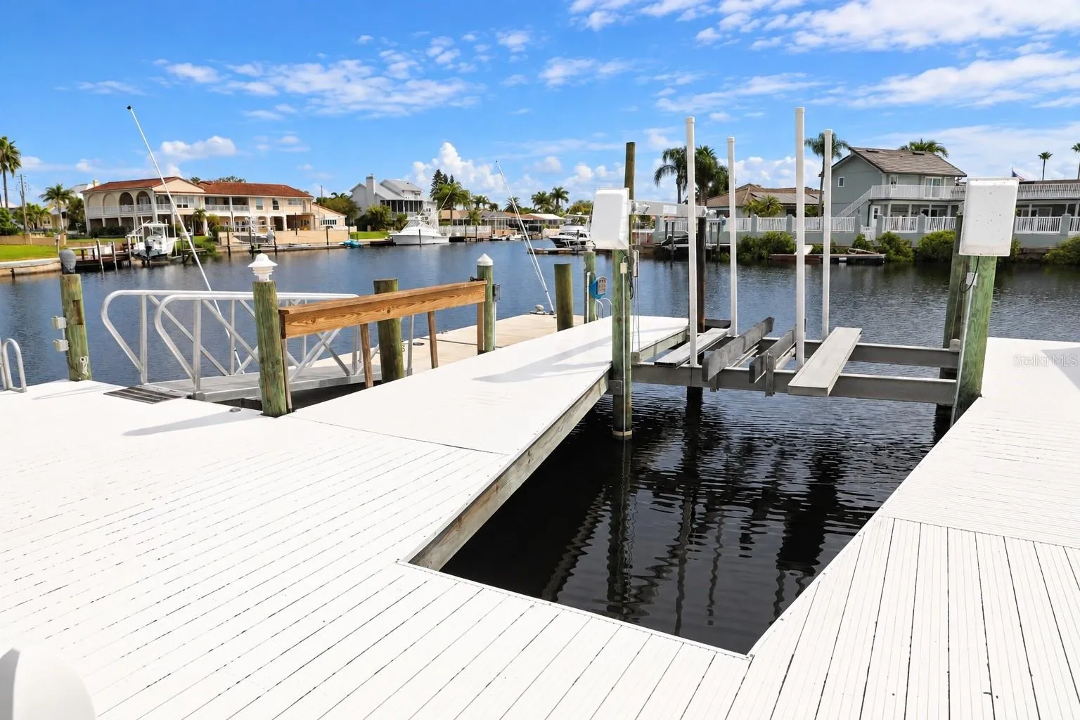Boat lift slip with open water views down the canal.