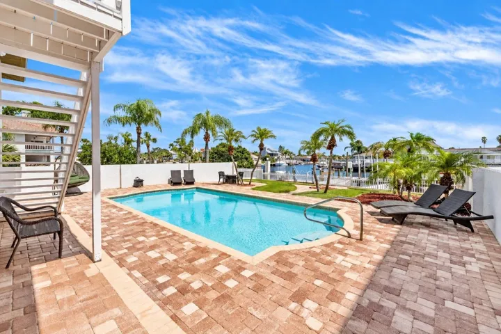 Heated pool with brick-paver deck.