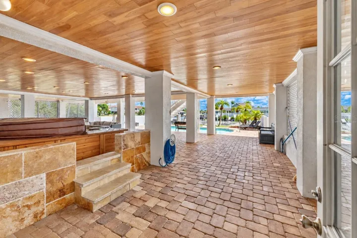 Covered ground-level lanai with hot tub.