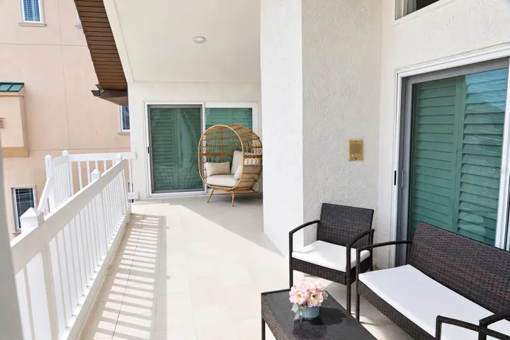 Wraparound rear balcony with seating and sliders to the living areas.