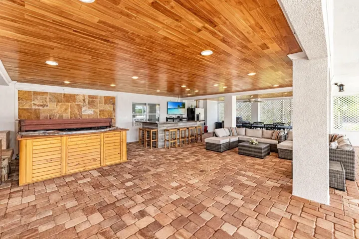 Covered entertaining area with hot tub and bar. Virtually staged – personal items digitally removed.