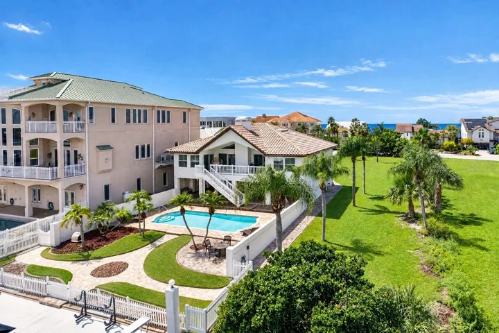Aerial view of the home, pool and backyard.